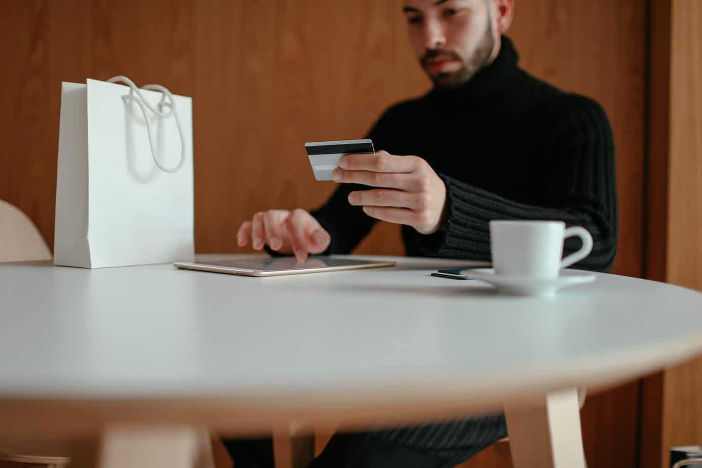 Man buying something on his tablet. Photo by Cup of Couple from Pexels