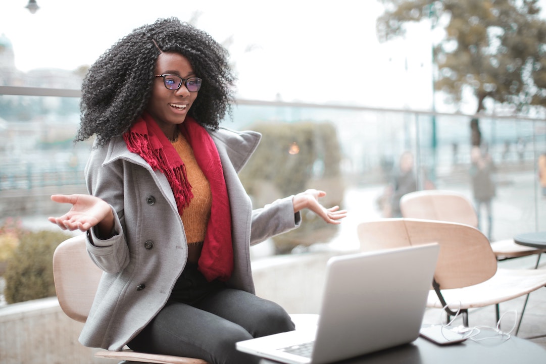 An cheerful woman in front of her computer - Photo by Andrea Piacquadio Pexels