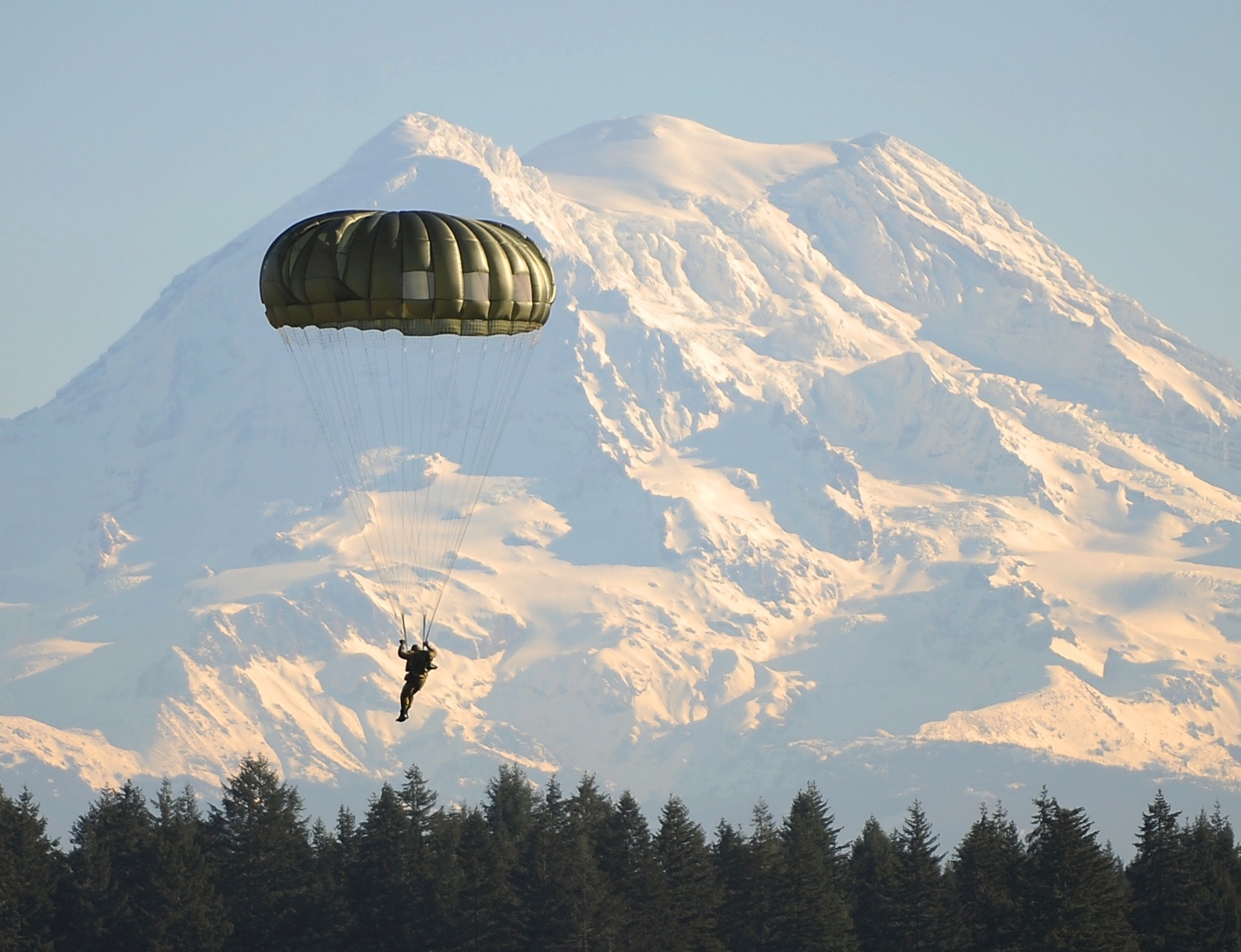 Parachute landing infront of a mountain