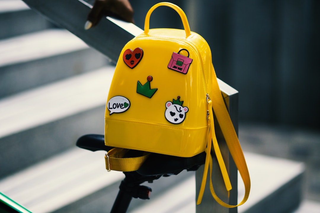 Yellow schoolbag hanging on a ramp with stairs
